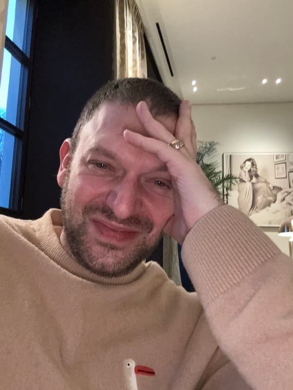 Man in brown sweater observed indoors in Milan