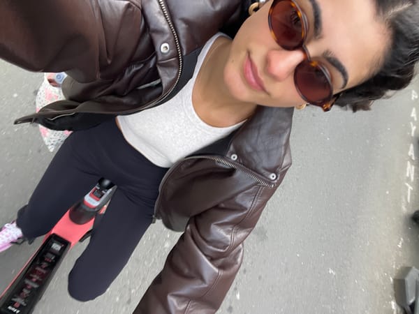 Woman rides pink electric scooter through Paris streets