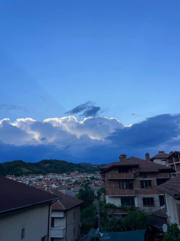 Zlatograd hillside town under a shifting late-afternoon sky