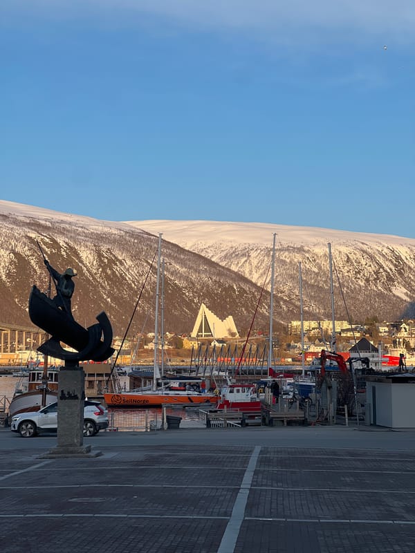 Maritime statue photographed at Tromsø harbor with snowy backdrop