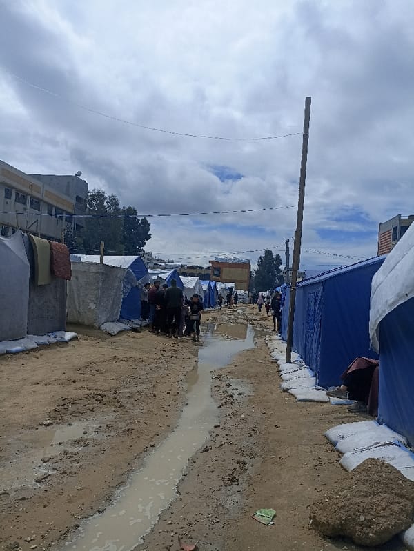 Temporary encampment documented in Gaza with muddy pathways