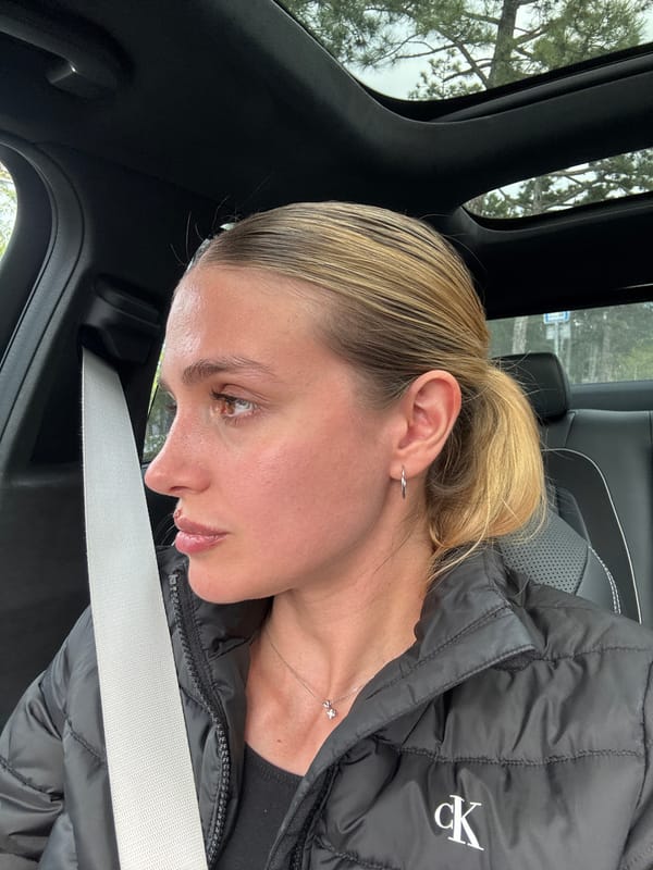 Woman with ponytail sits in vehicle in Tbilisi