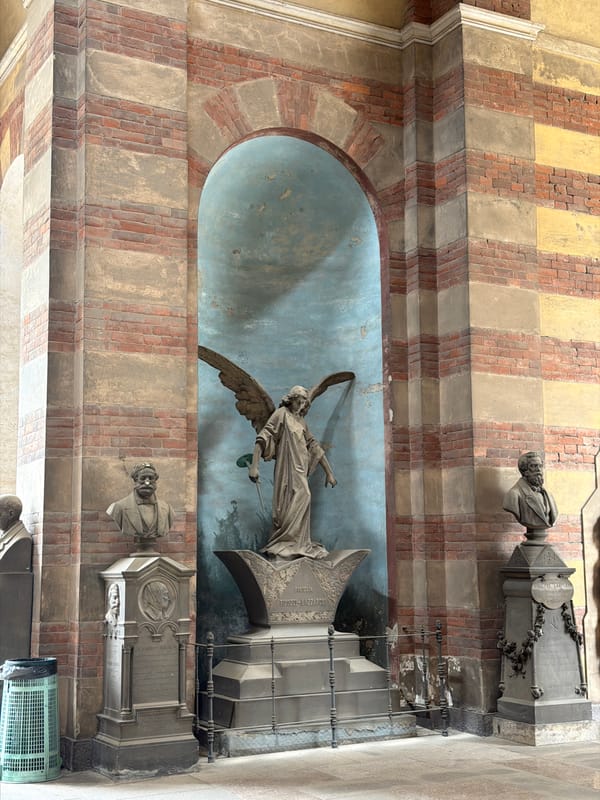 Visitor documents ornate architecture at Milan's Monumental Cemetery