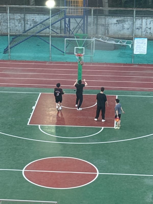 People gather on outdoor basketball court in Beijing suburb
