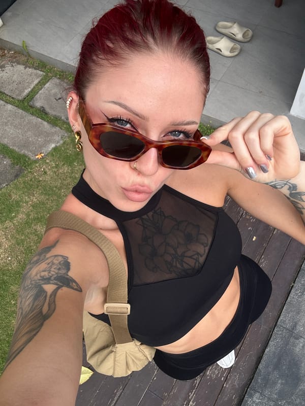 Woman takes selfies in North Kuta, Indonesia morning