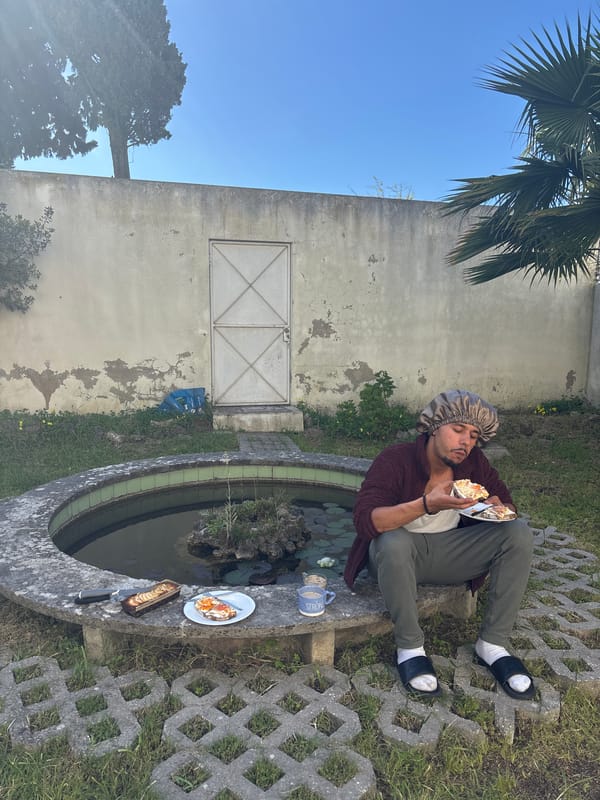 Man eats meal beside water feature in Lisbon