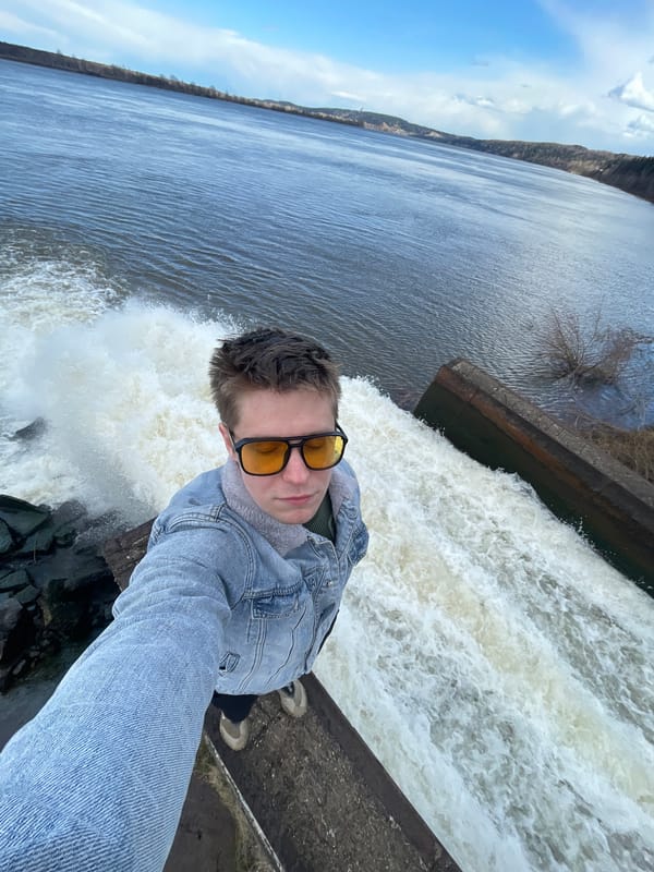 Young person takes selfie at waterfall edge