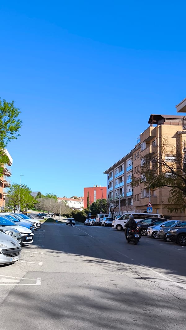 Motorcyclist travels residential street in Ripollet, Spain