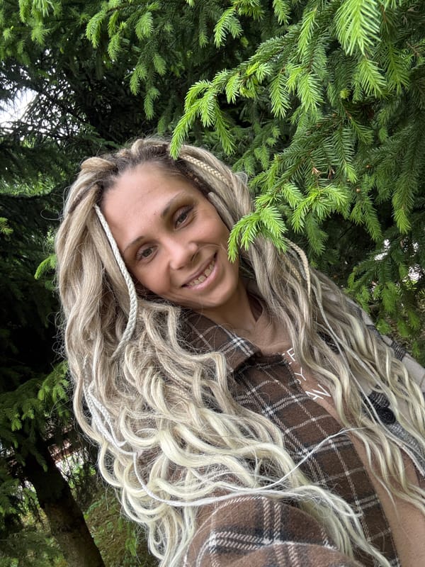 Woman photographed smiling in wooded area near Rusanovo, Russia