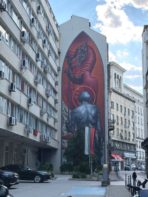 Bold figurative mural dominates a building wall in Sofia