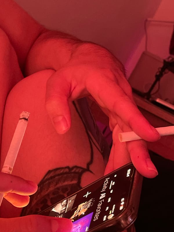 Belgrade resident captured in dimly lit indoor scene with phone