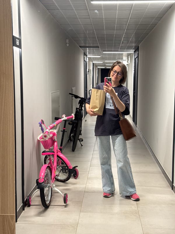 Arriving home in Izhevsk with flowers and a paper bag