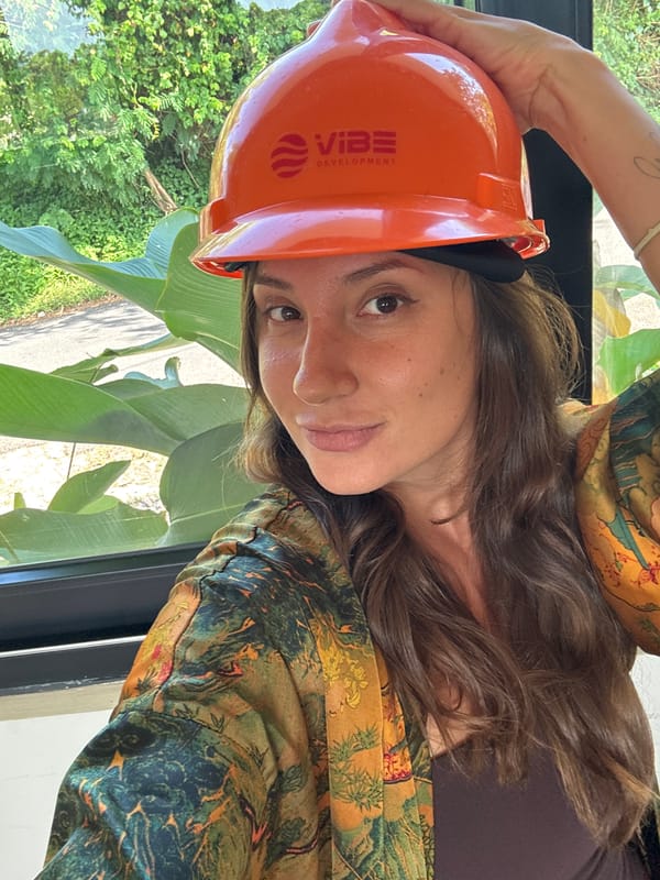 Woman poses with Vibe Development hard hat in Kuta Selatan