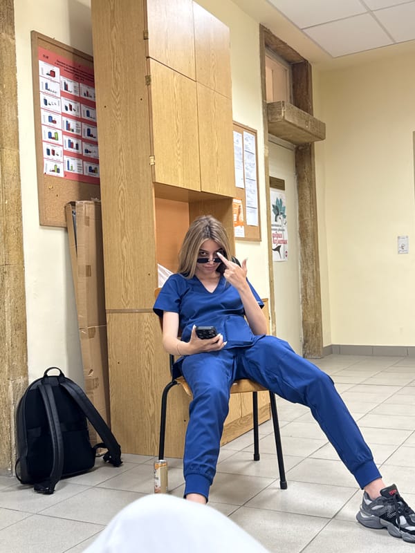 Medical worker in scrubs takes phone break in Pleven