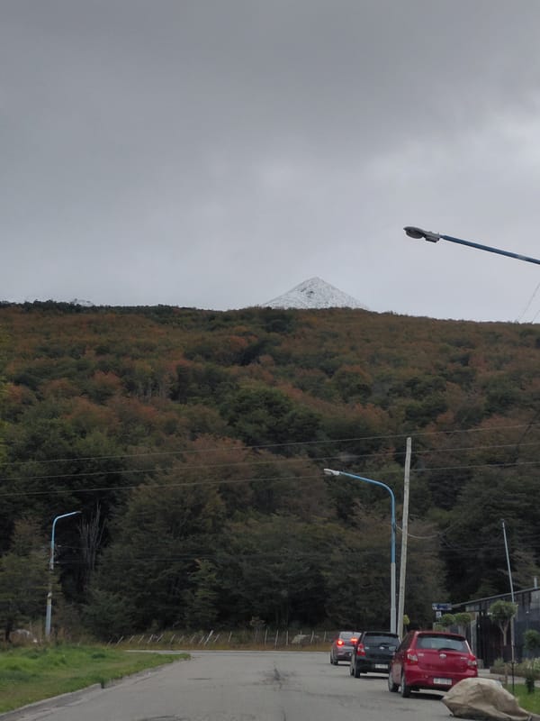 Vehicles parked in Ushuaia with mountain backdrop