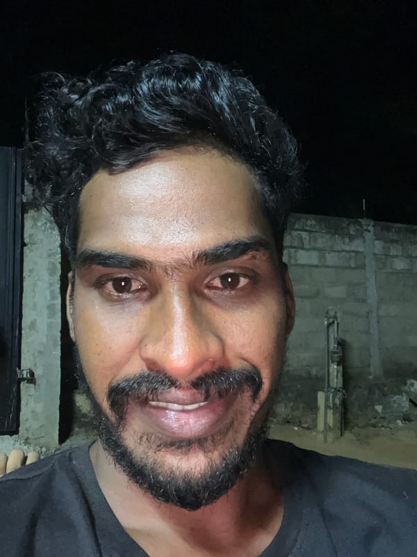 Portrait of smiling man captured at night in Arugam Bay