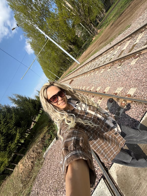 Person photographed near railroad tracks in rural Russia
