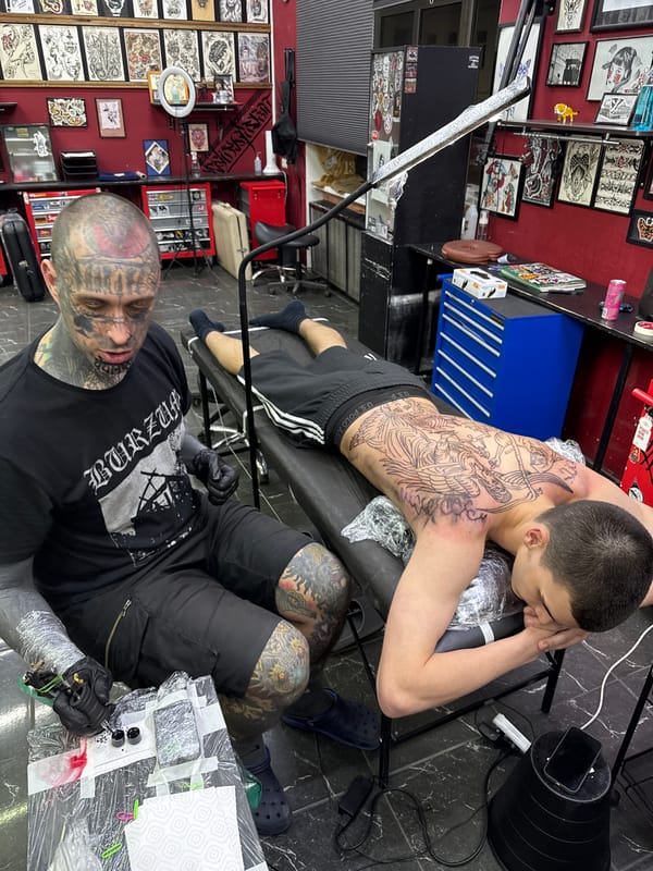 Tattoo artist works on elaborate back piece in Moscow studio