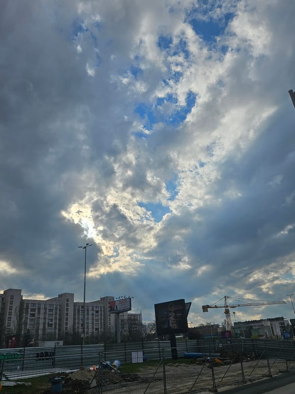 Cloudy afternoon sky observed over Sofia with construction crane visible