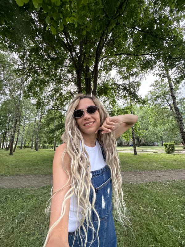 Woman poses for outdoor photo session in Russian village park