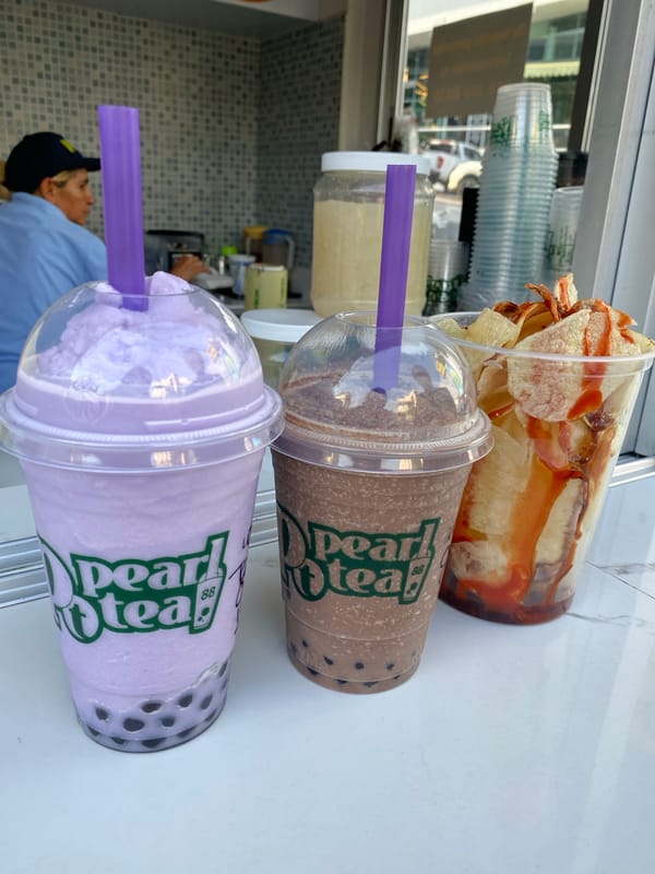 Urban evening captures boba tea, World Cup stickers, convenience shopping