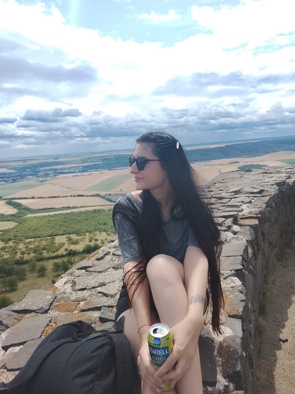 Exploring Czech hilltop castle ruins on a partly cloudy summer morning