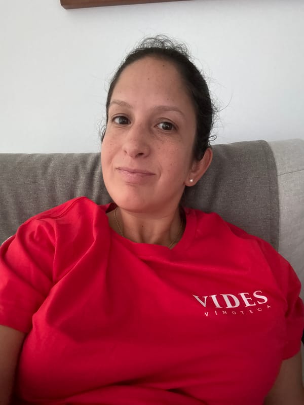 Woman rests on cushion in San Isidro wearing wine bar shirt