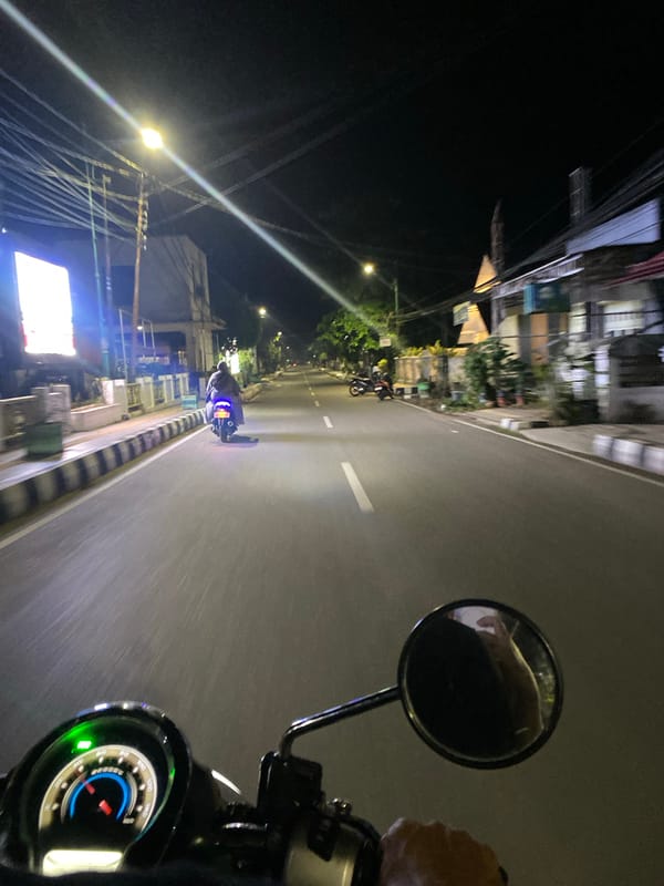 Nighttime motorcycle traffic documented on Tanjung road