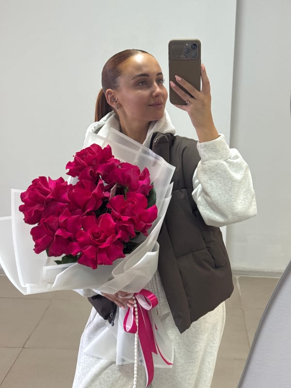 Woman takes flower bouquet selfies in Chaikovsky, Russia
