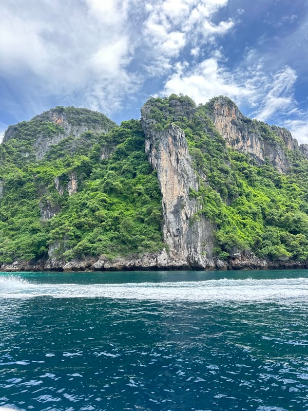 Speedboat crossing Andaman Sea past Ao Nang's karst cliffs