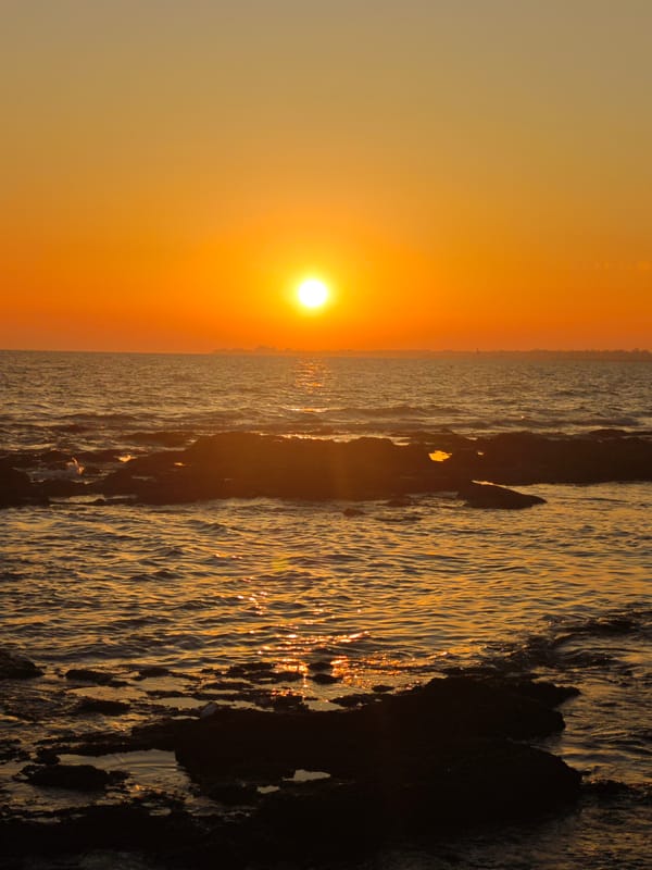 Atlantic sunset fades from white to red off Costa Oeste