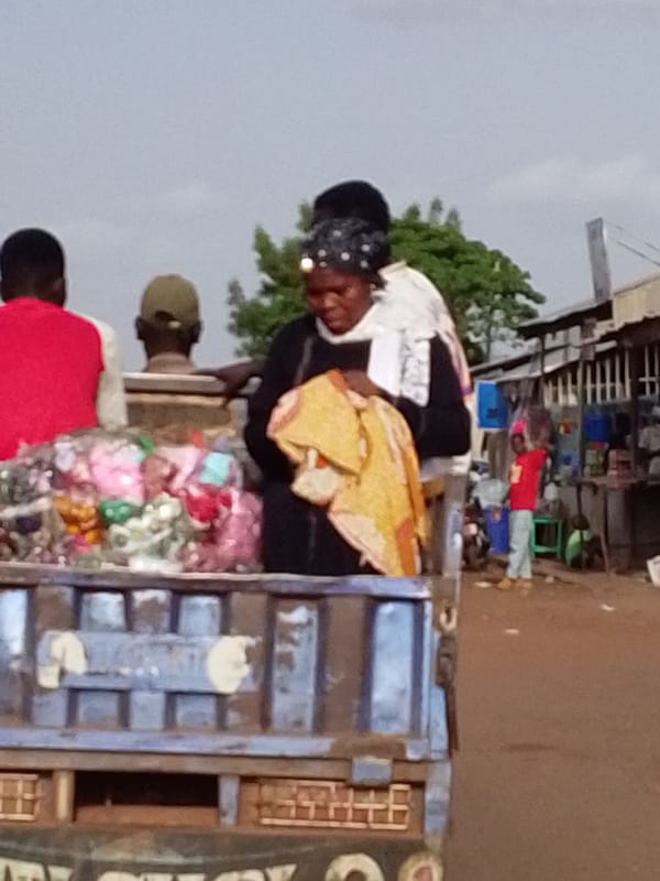 Utility truck transports people and goods through Tamale market