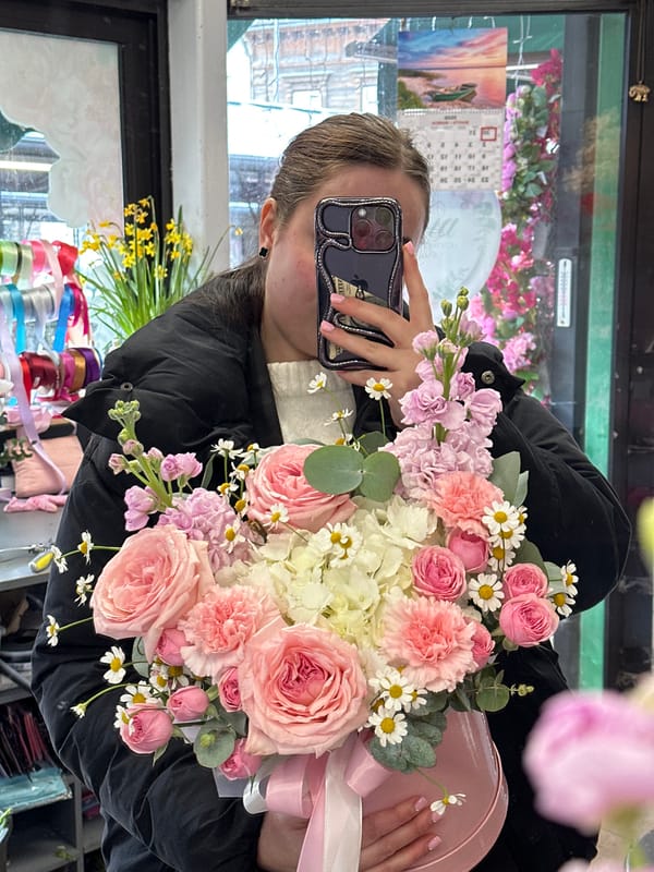 Woman shops for flowers, documents bouquets in Liepaja