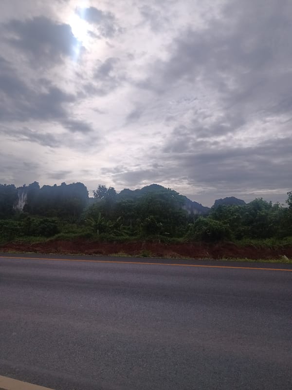 Tourist documents scenic mountain drive through Plai Phraya, Thailand