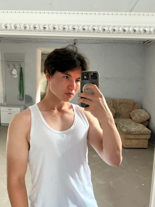 Mirror selfie session in a tiled indoor room.