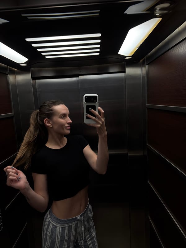 Woman takes rotated mirror selfie in Budva elevator