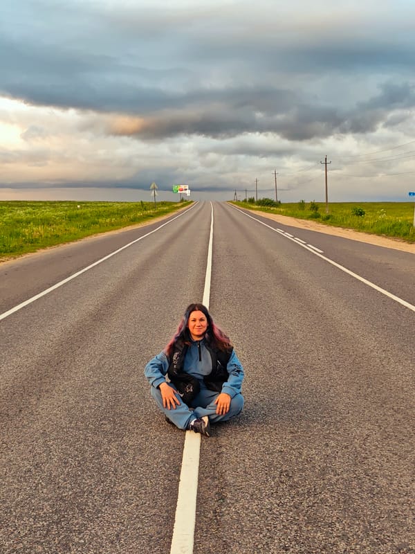 Woman sits in road center line near Курово, Russia