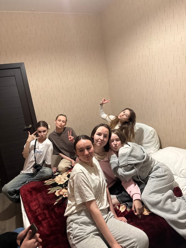 Young women dancing and socializing in Кашино home