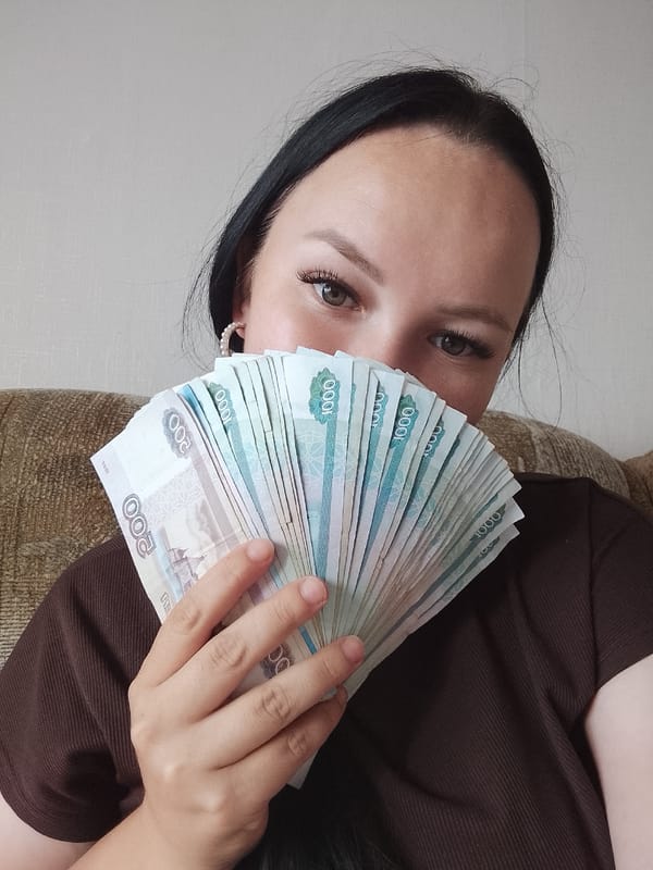 Woman photographed with Russian banknotes in Kuyeda, Russia