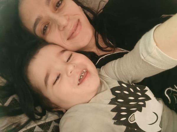 Mother and child share early morning bonding time watching cartoons