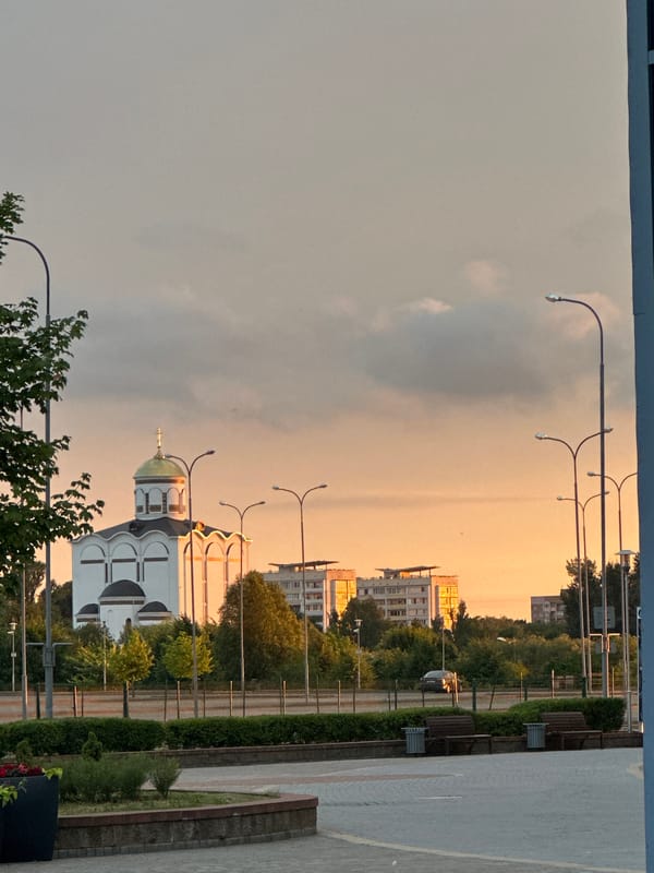 MAZ trucks and Minsk Arena at golden hour
