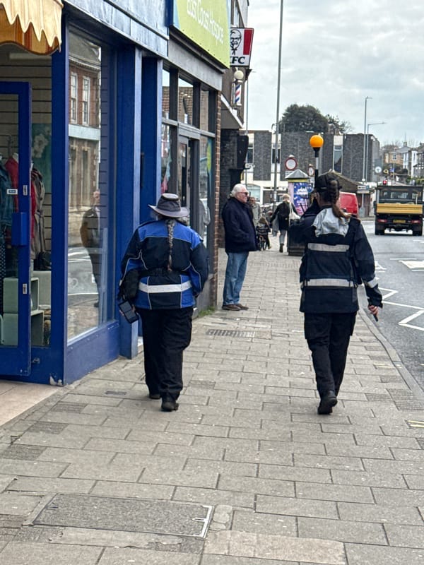Pedestrians walk past storefronts on Gorleston-on-Sea High Street