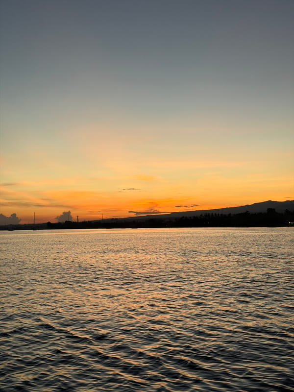 Dusk reflection captured on water in Kalibukbuk, Indonesia