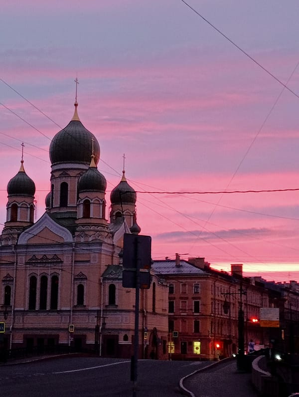 Saint Petersburg streets and skyline glow under a summer sunset
