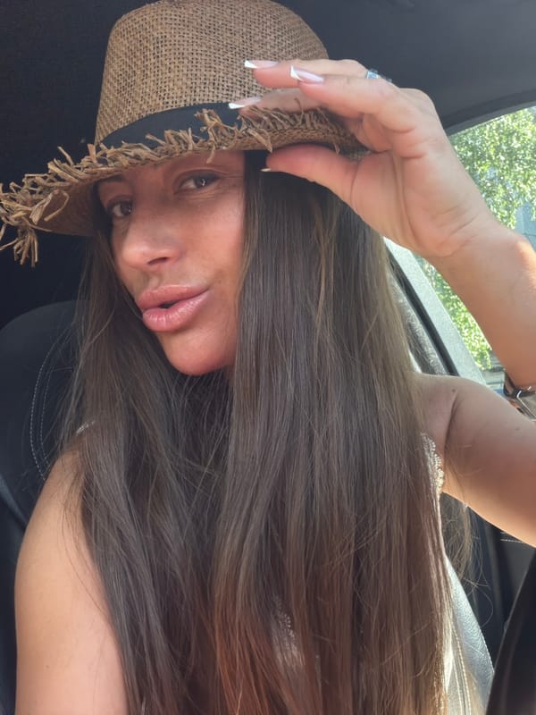 Straw hat, sunglasses, and a car window view in Novosibirsk