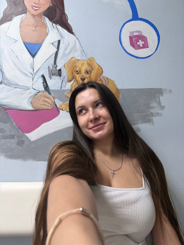 Woman visits veterinary clinic with golden retriever mural