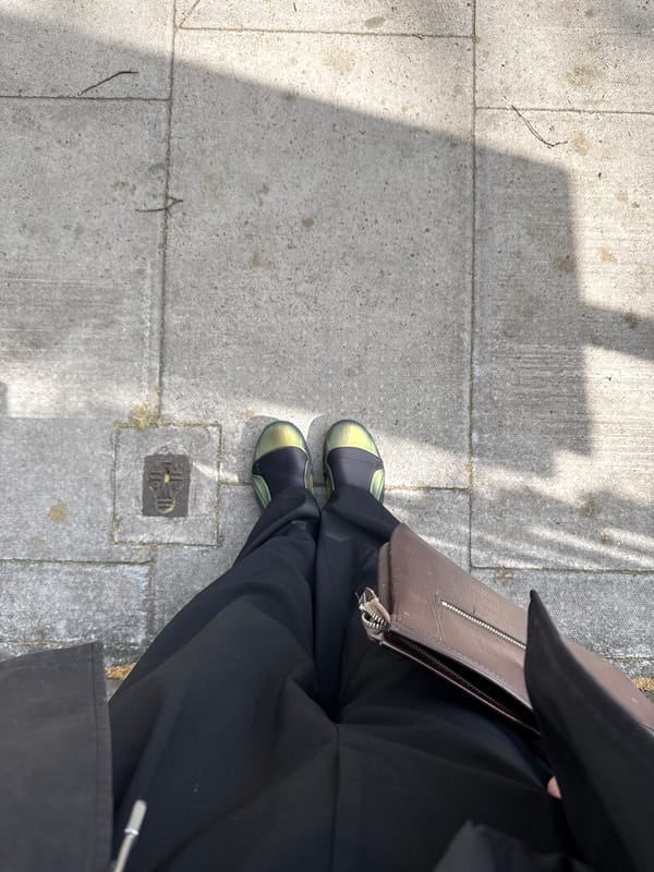 Person stands on London sidewalk Tuesday morning