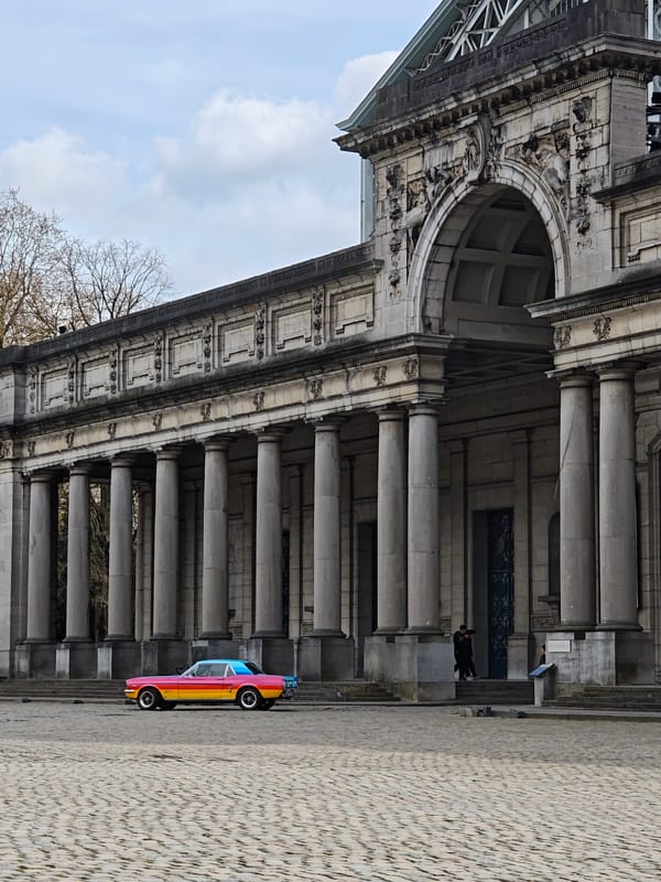 Vintage car parked at classical Brussels building