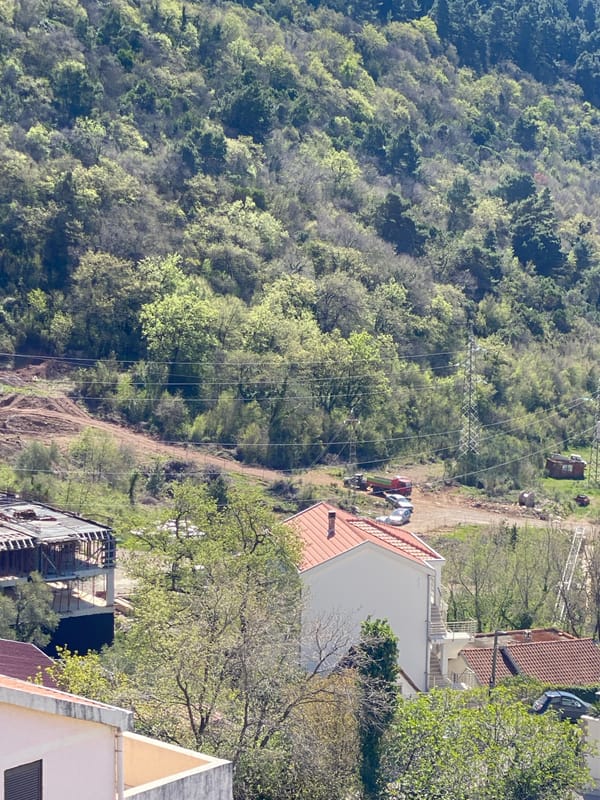 Budva Montenegro hillside construction activity observed April morning