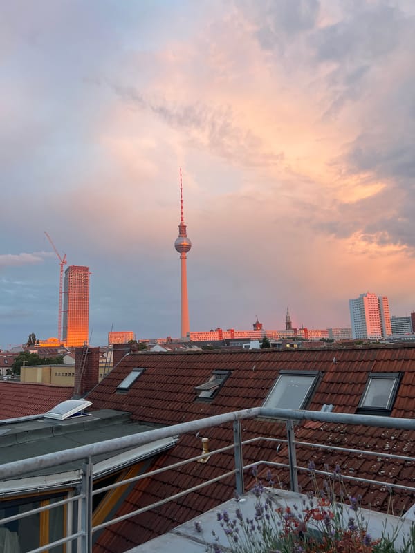 Berlin rooftop at golden hour with food prep underway